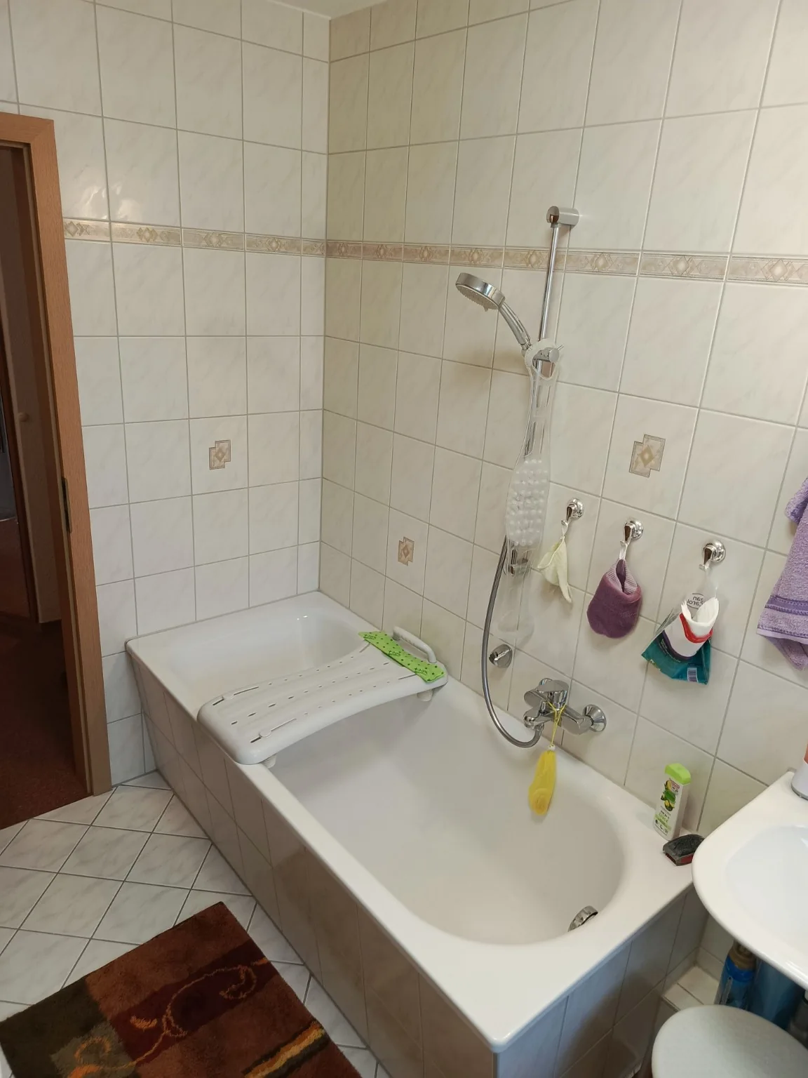 Vorher: Badewanne mit hohem Einstieg und Wannensitzhilfe.